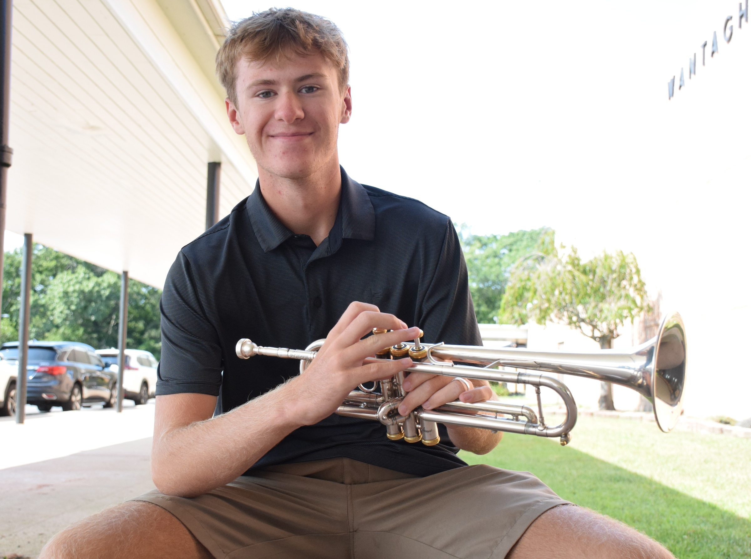 boy holding trumpet